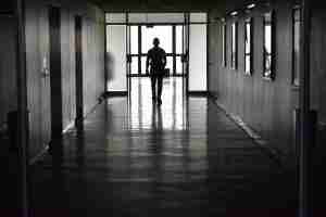 dark silhouette of a man in a hallway