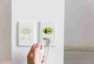 hand pushing nurse call button