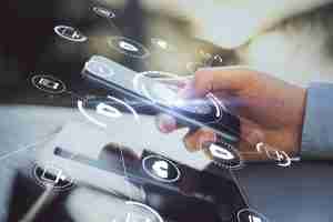 person holding a cell phone with floating icons to represent integrated security systems