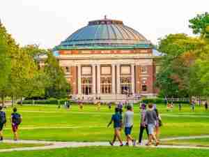 students walking across a college campus