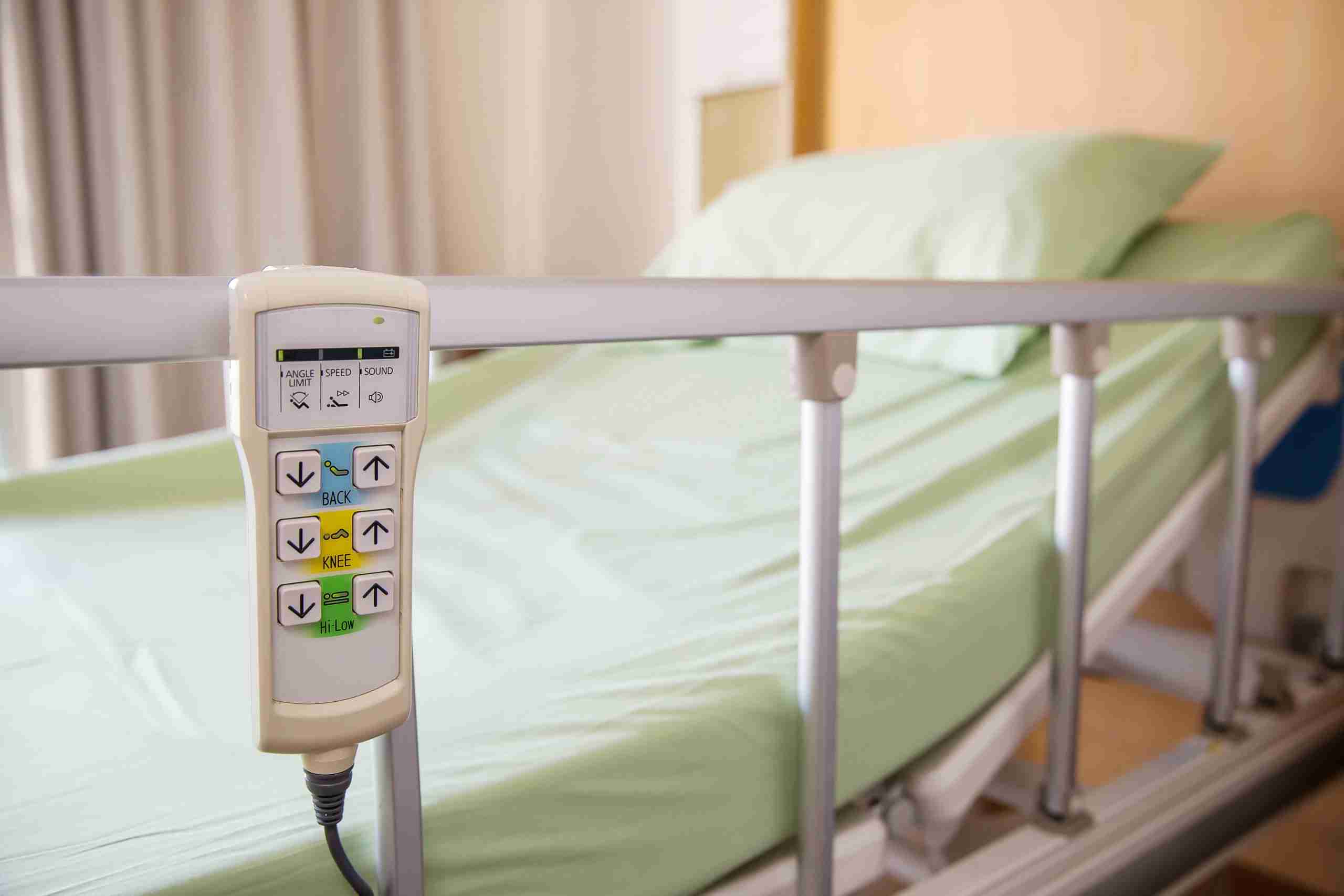 hospital bed with call system remote hanging on bed rail